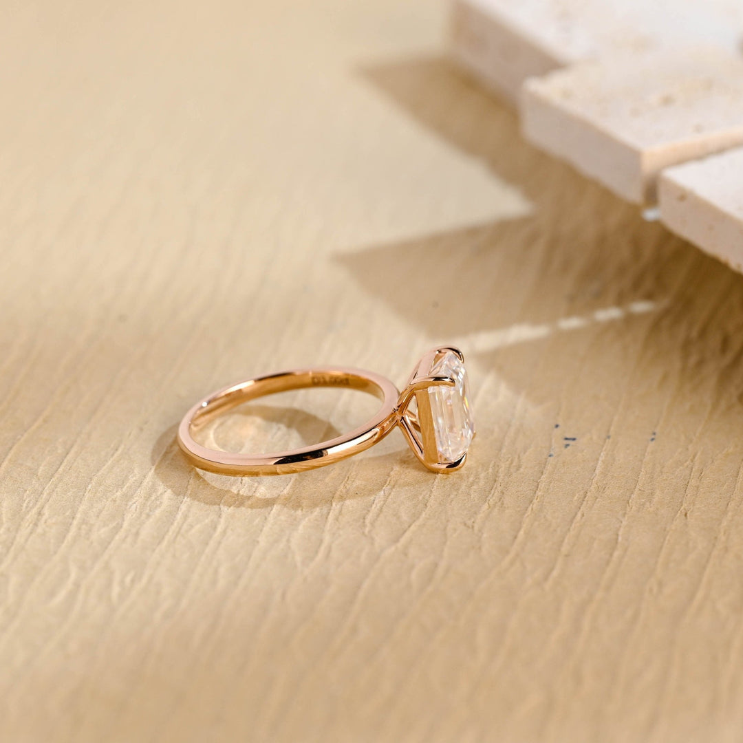 Emerald solitaire engagement ring shown on hand for true-to-life sizing
