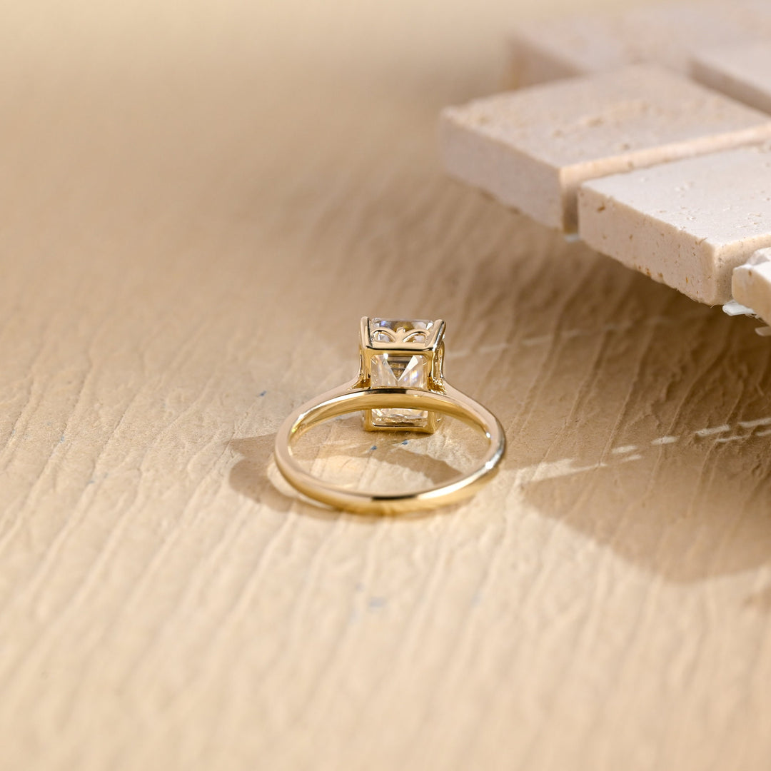 Emerald solitaire lab grown diamond ring side profile in gold setting