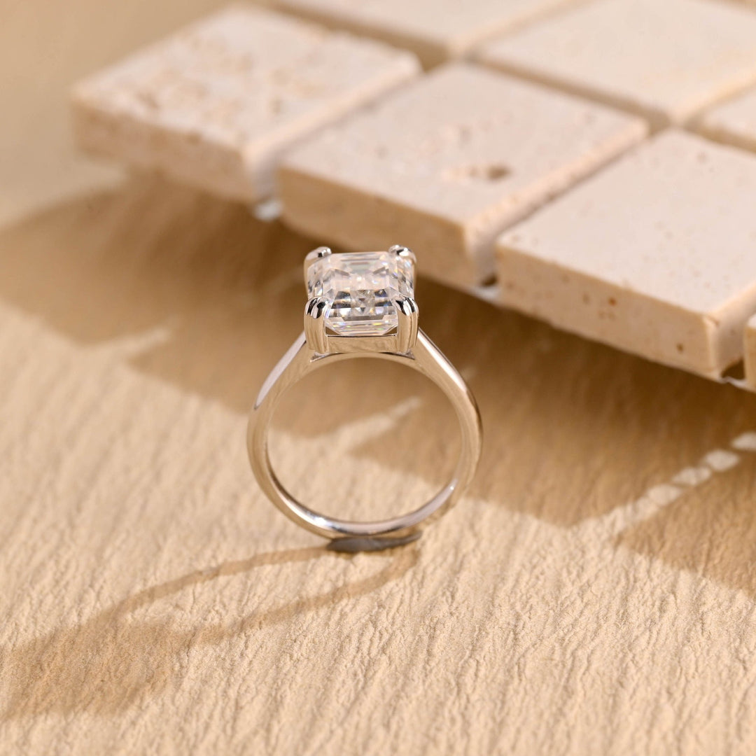 Emerald solitaire engagement ring photographed in natural light