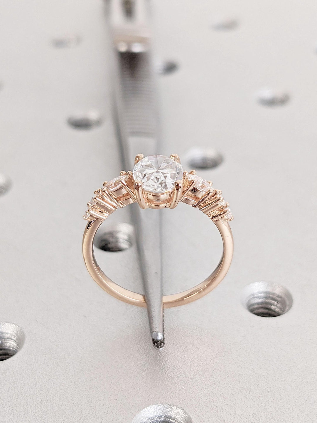 Round cluster engagement ring shown on hand for true-to-life sizing
