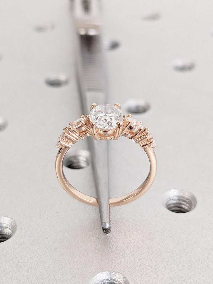 Round cluster engagement ring shown on hand for true-to-life sizing