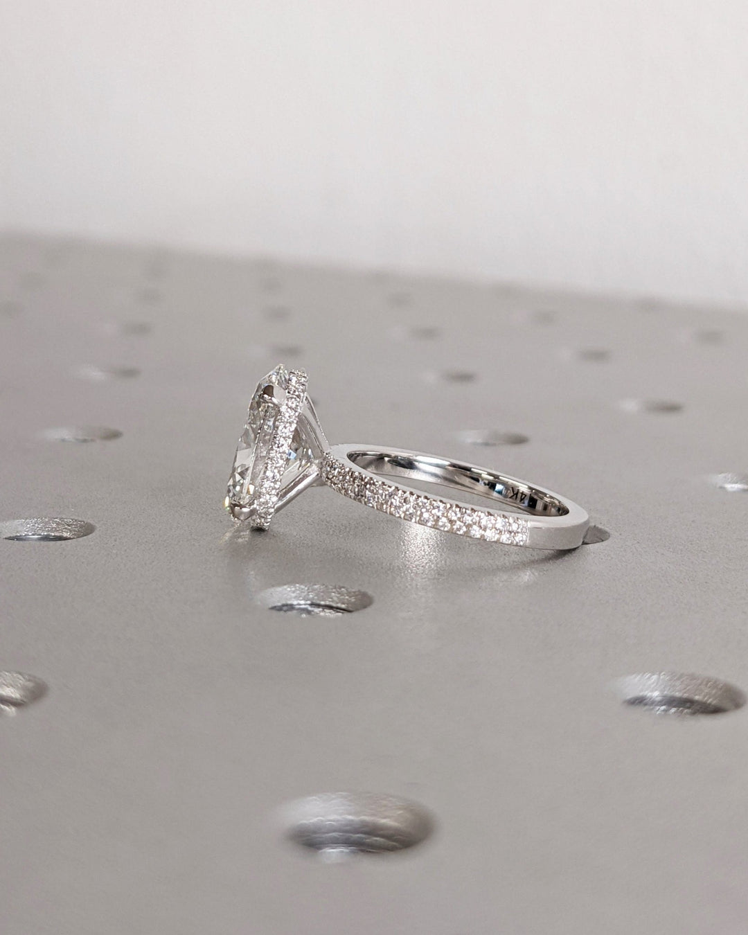 Oval cut hidden halo engagement ring with IGI certified center diamond