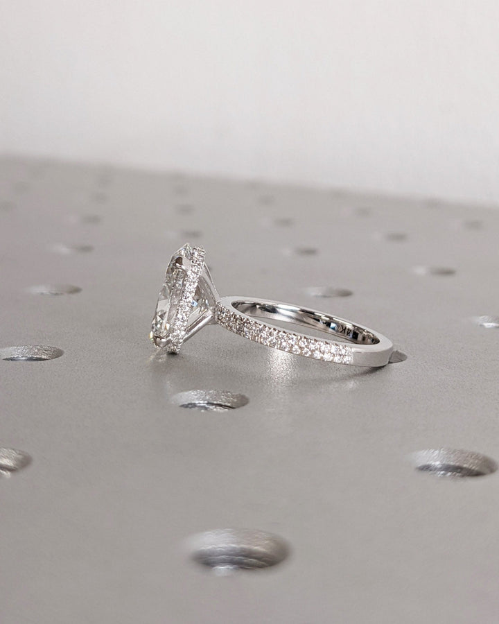 Oval cut hidden halo engagement ring with IGI certified center diamond