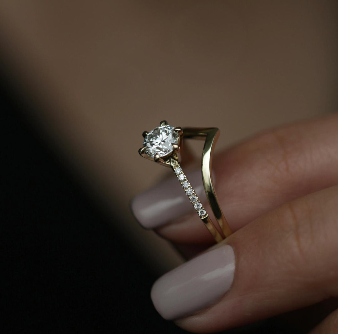 Round solitaire engagement ring shown on hand for true-to-life sizing