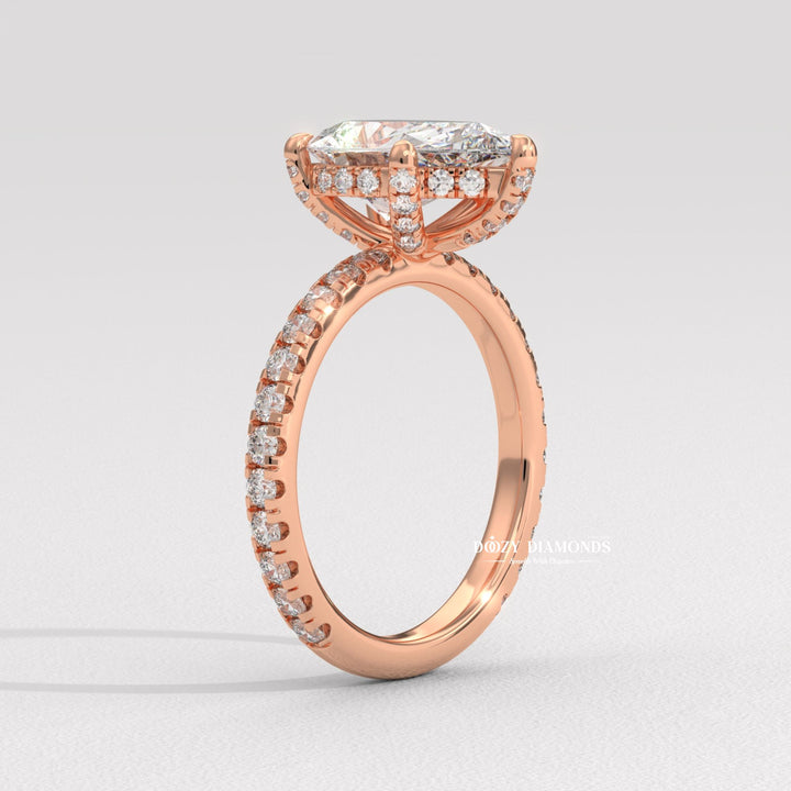 Close-up of pear cut center diamond in hidden halo engagement ring