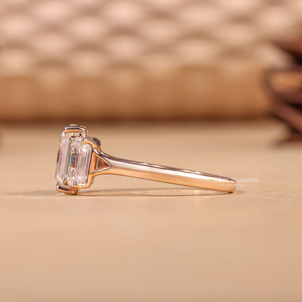 Emerald three stone diamond ring presented in signature gift packaging