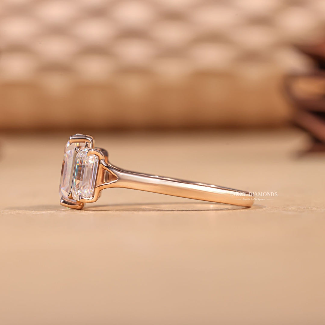 Emerald three stone diamond ring presented in signature gift packaging