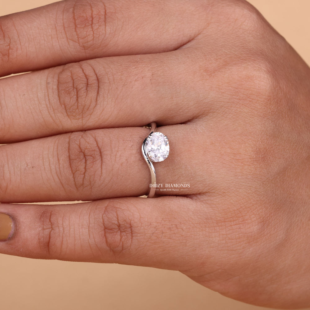 Oval solitaire engagement ring shown on hand for true-to-life sizing
