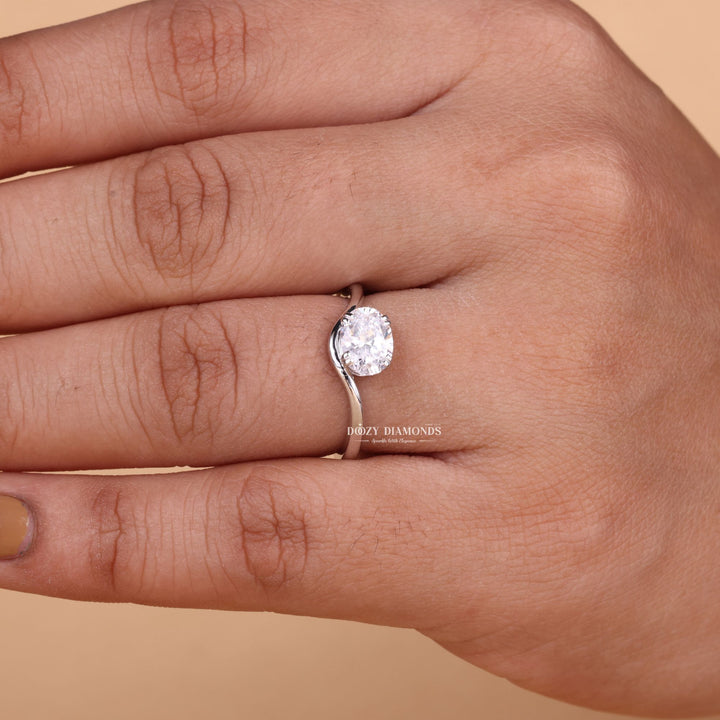 Oval solitaire engagement ring shown on hand for true-to-life sizing
