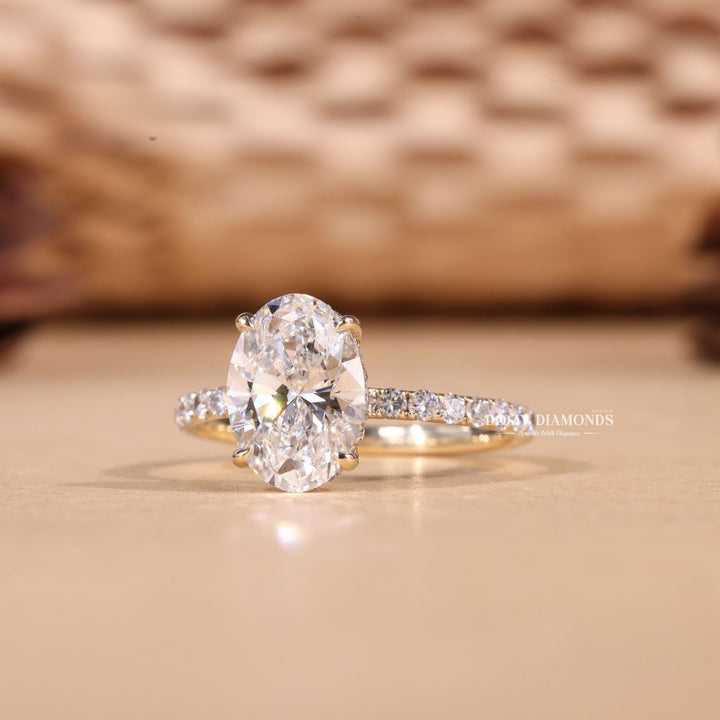 Lifestyle shot of oval hidden halo diamond ring on hand
