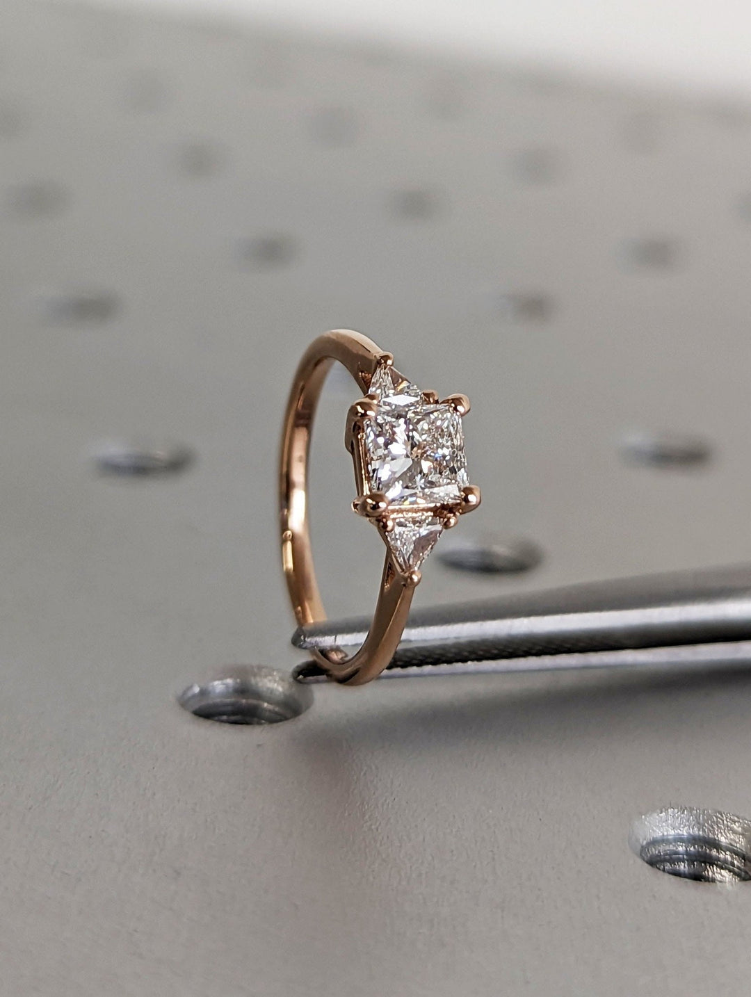 Princess three stone engagement ring with brilliant diamond sparkle