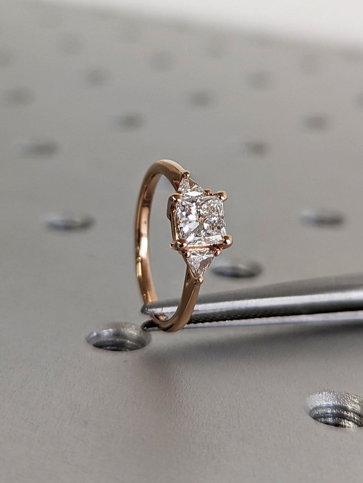 Princess three stone engagement ring with brilliant diamond sparkle