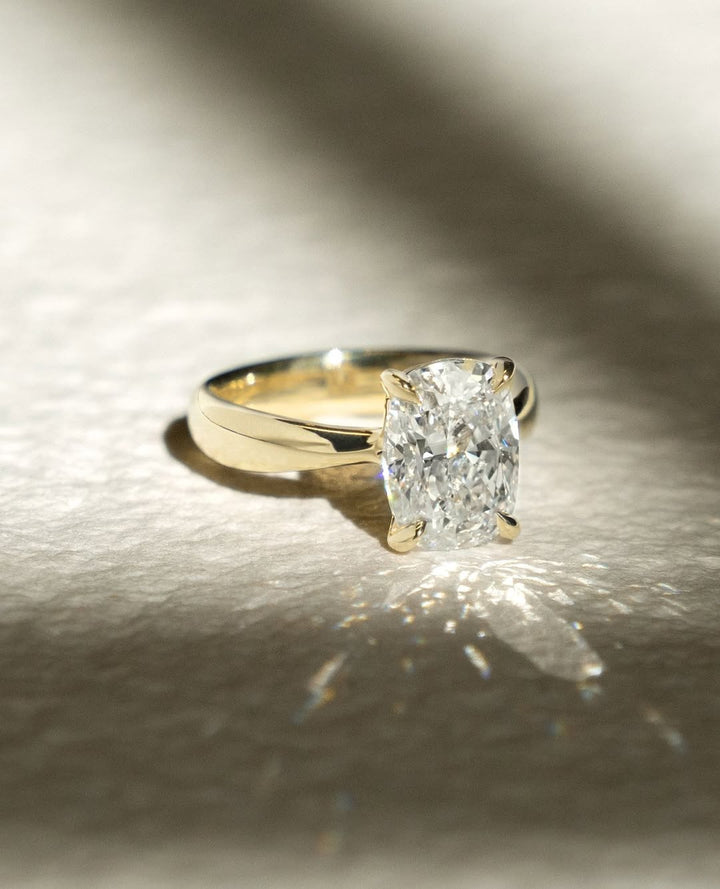 Cushion cut engagement ring side view showing band detail
