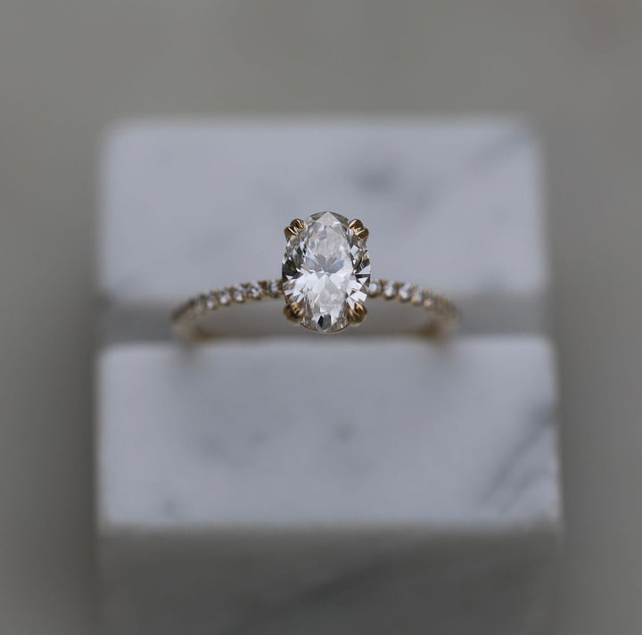 Oval solitaire engagement ring viewed from the side