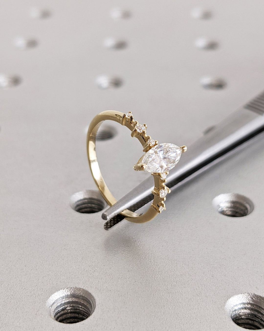Marquise pave diamond ring displayed on jewelry stand