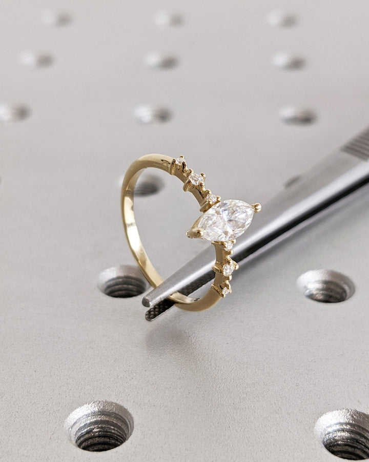 Marquise pave diamond ring displayed on jewelry stand
