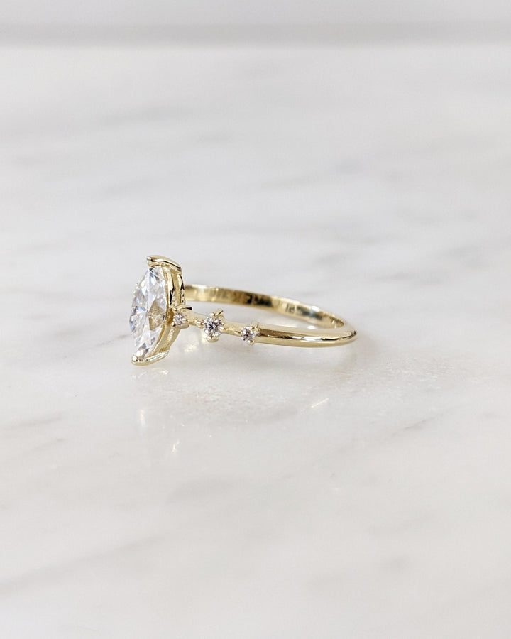 Angled view of marquise cut diamond in pave setting