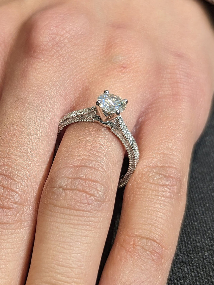 Unboxing view of round cut vintage diamond engagement ring