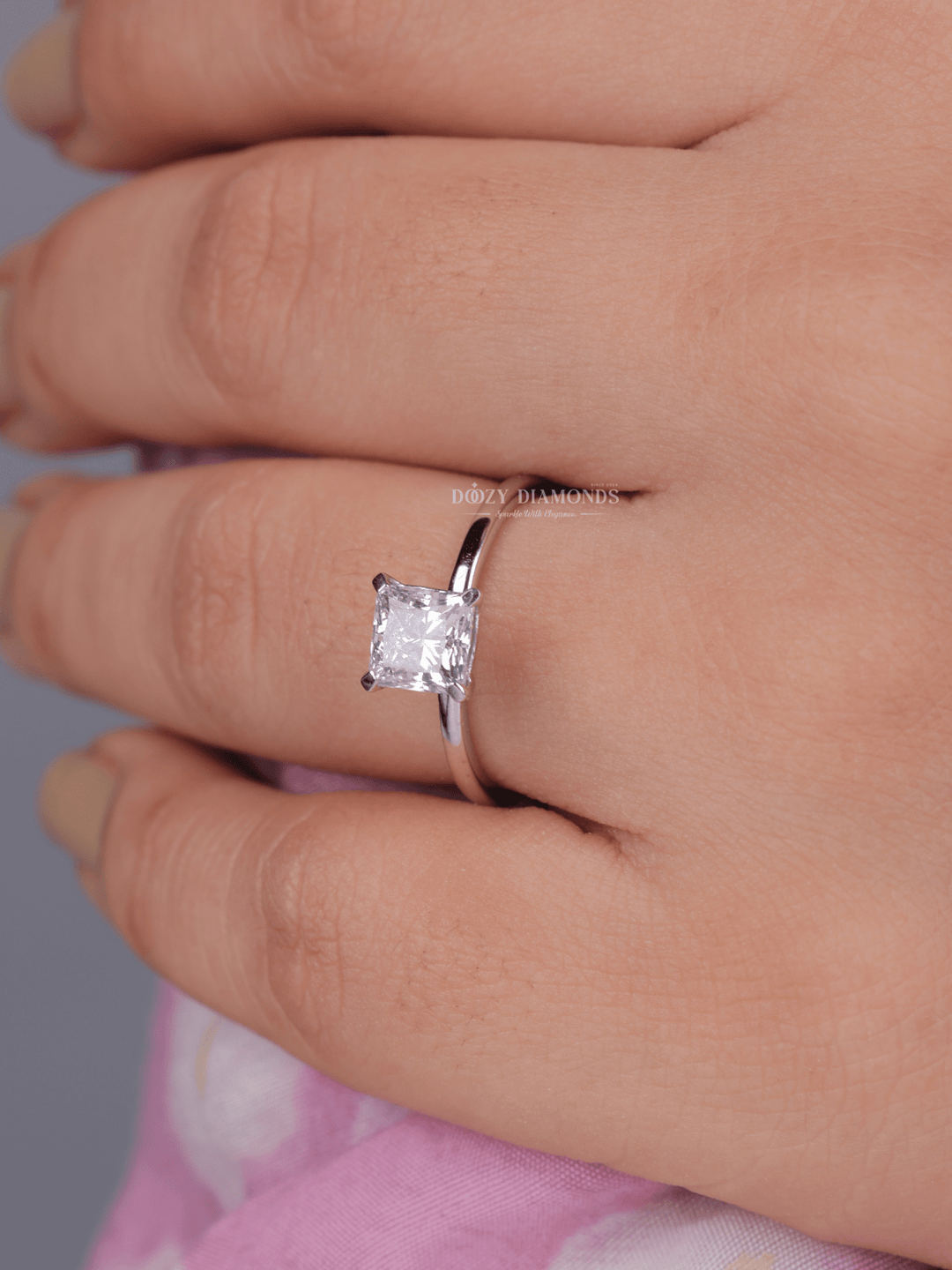 Detailed close-up of princess solitaire diamond engagement ring