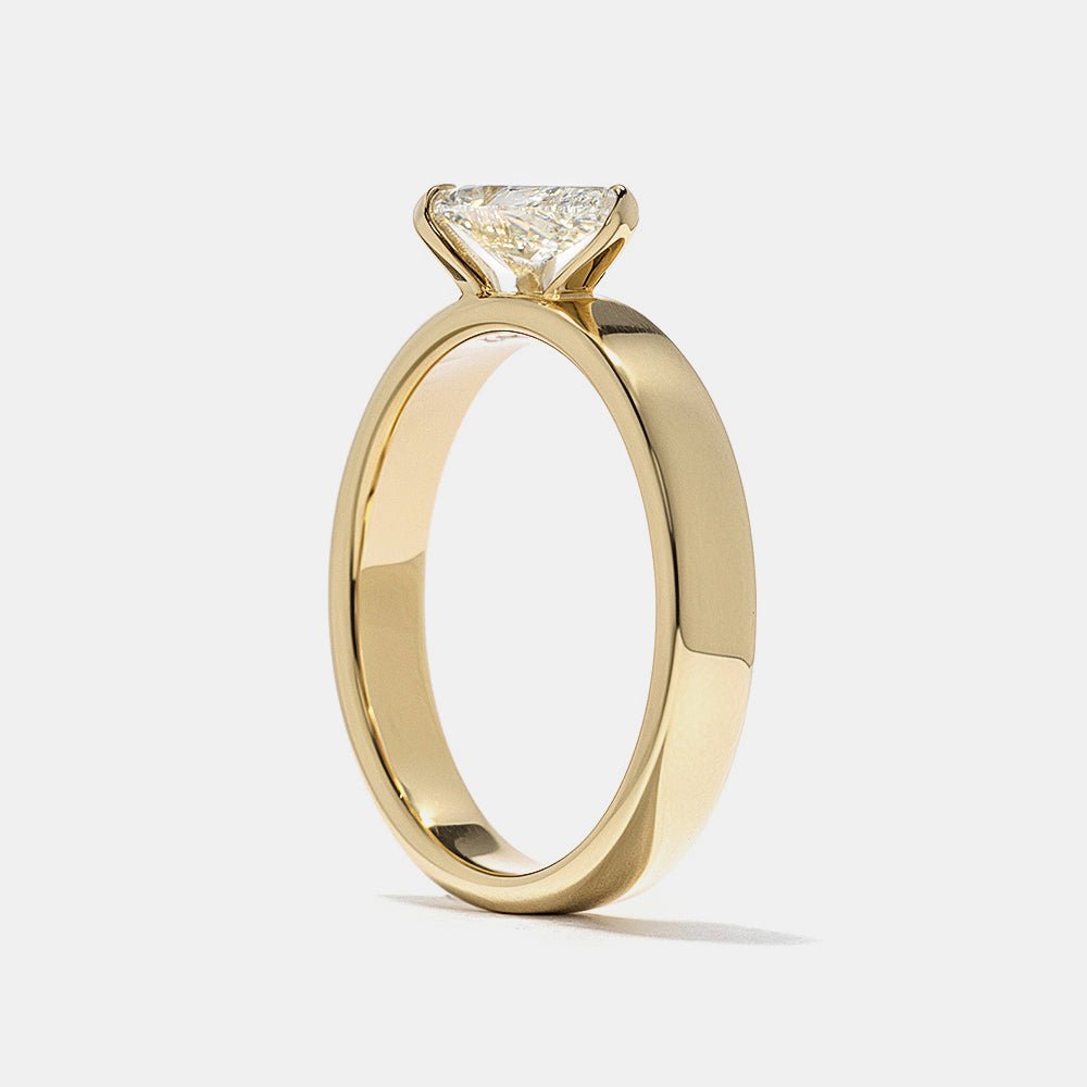 Profile view of pear cut east west engagement ring band