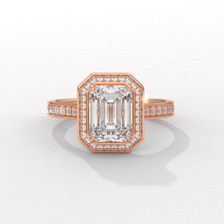 Emerald halo engagement ring shown on hand for true-to-life sizing