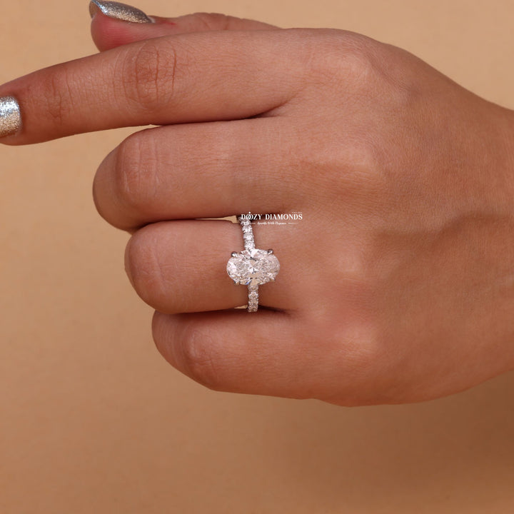 Angled view of oval cut diamond in hidden halo setting