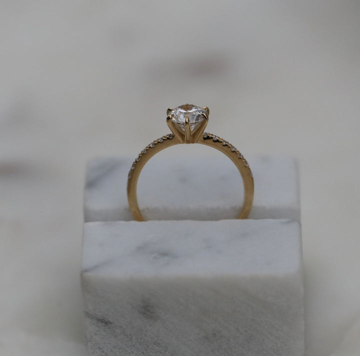 Detailed close-up of round solitaire diamond engagement ring