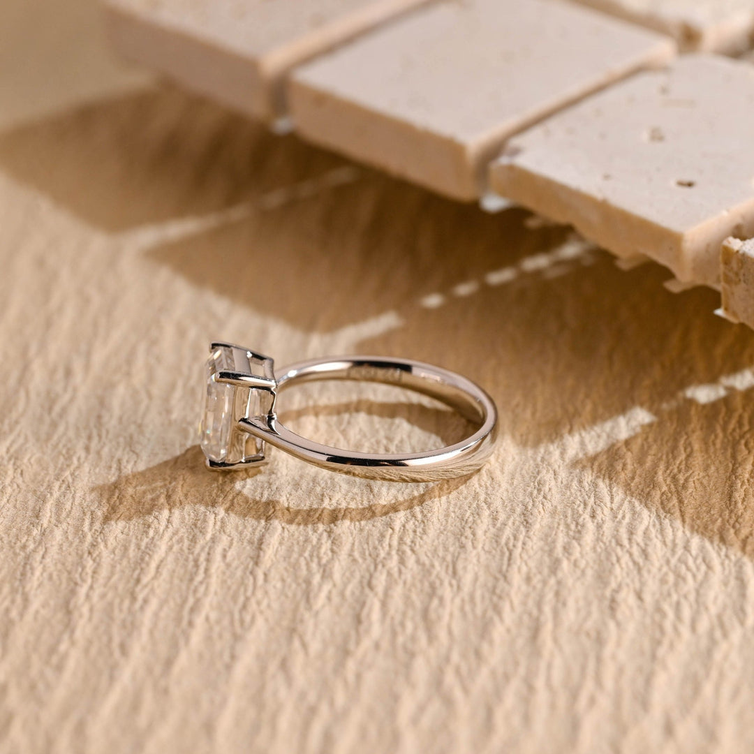 Emerald solitaire diamond ring presented in signature gift packaging