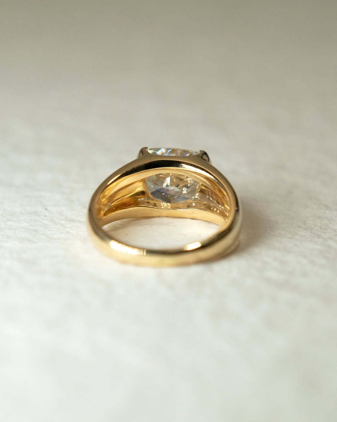 Cushion bezel engagement ring close-up highlighting diamond sparkle