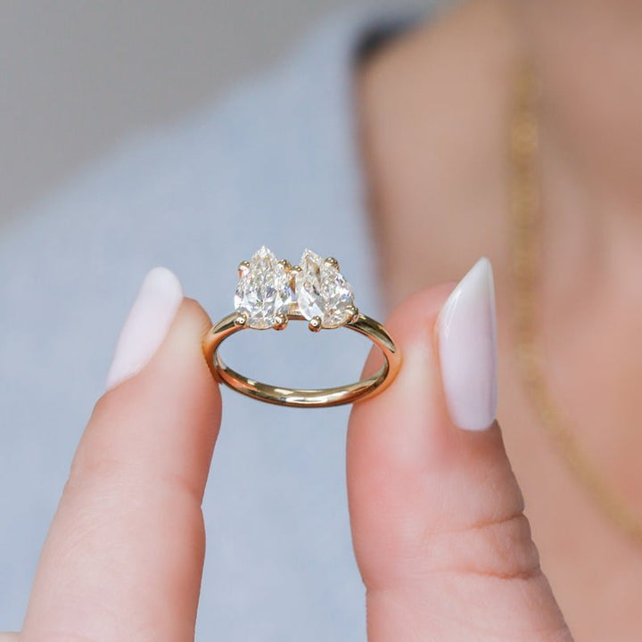 Pear solitaire engagement ring shown on hand for true-to-life sizing