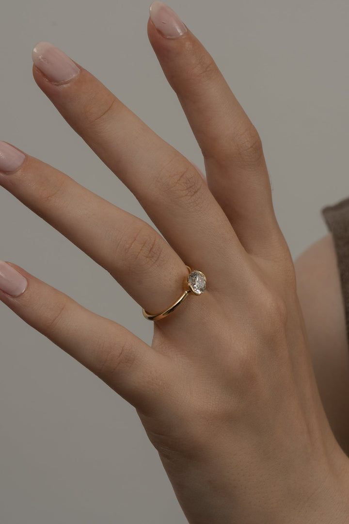 Round bezel engagement ring with brilliant diamond sparkle