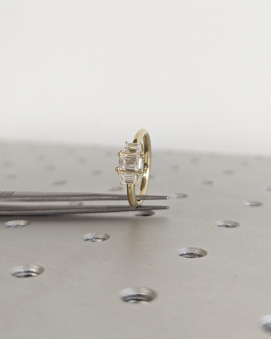Side angle of emerald solitaire diamond engagement ring