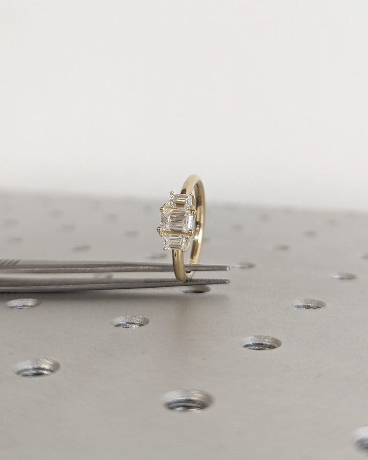 Side angle of emerald solitaire diamond engagement ring