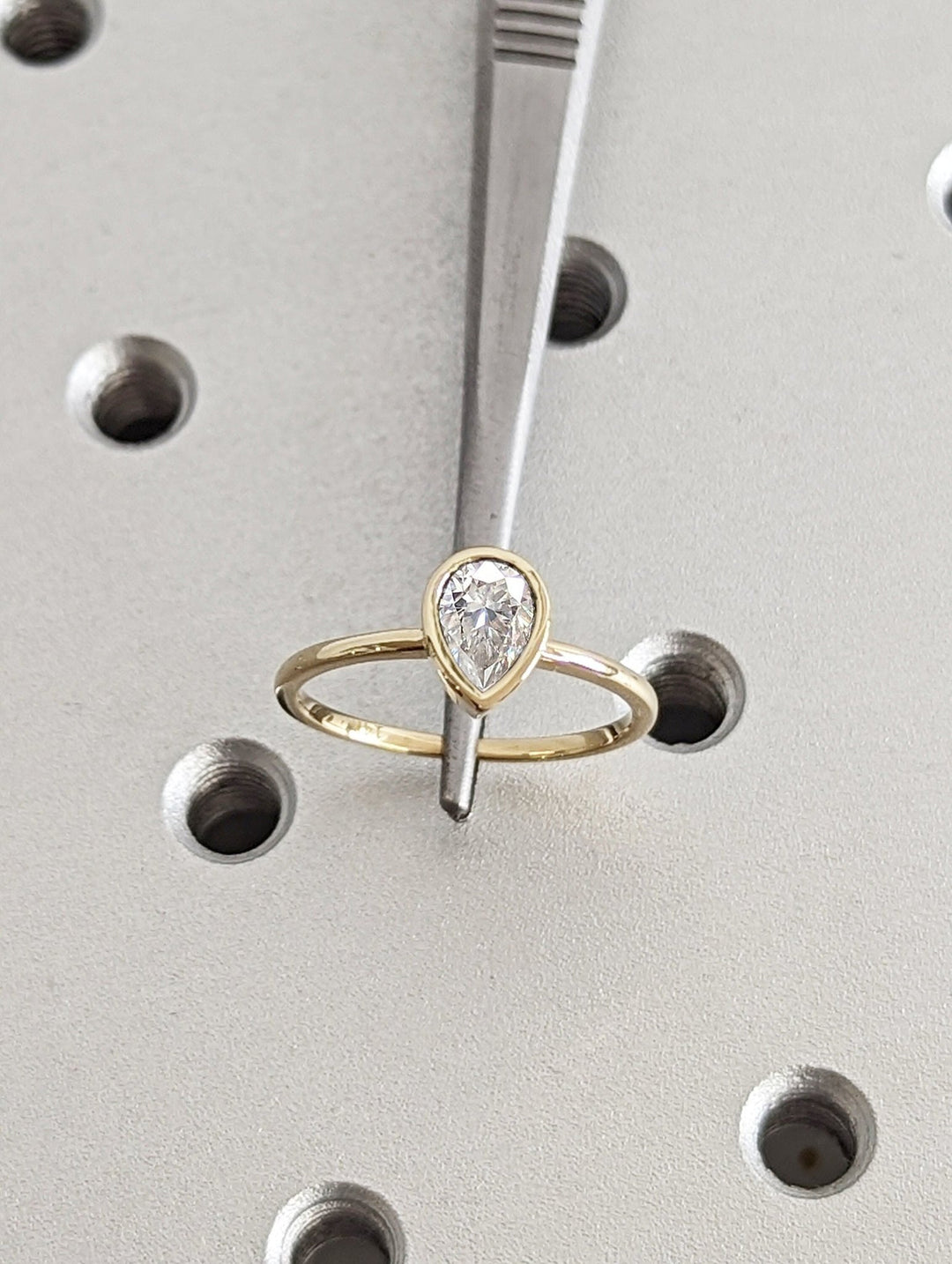 Top-down view of pear cut bezel engagement ring