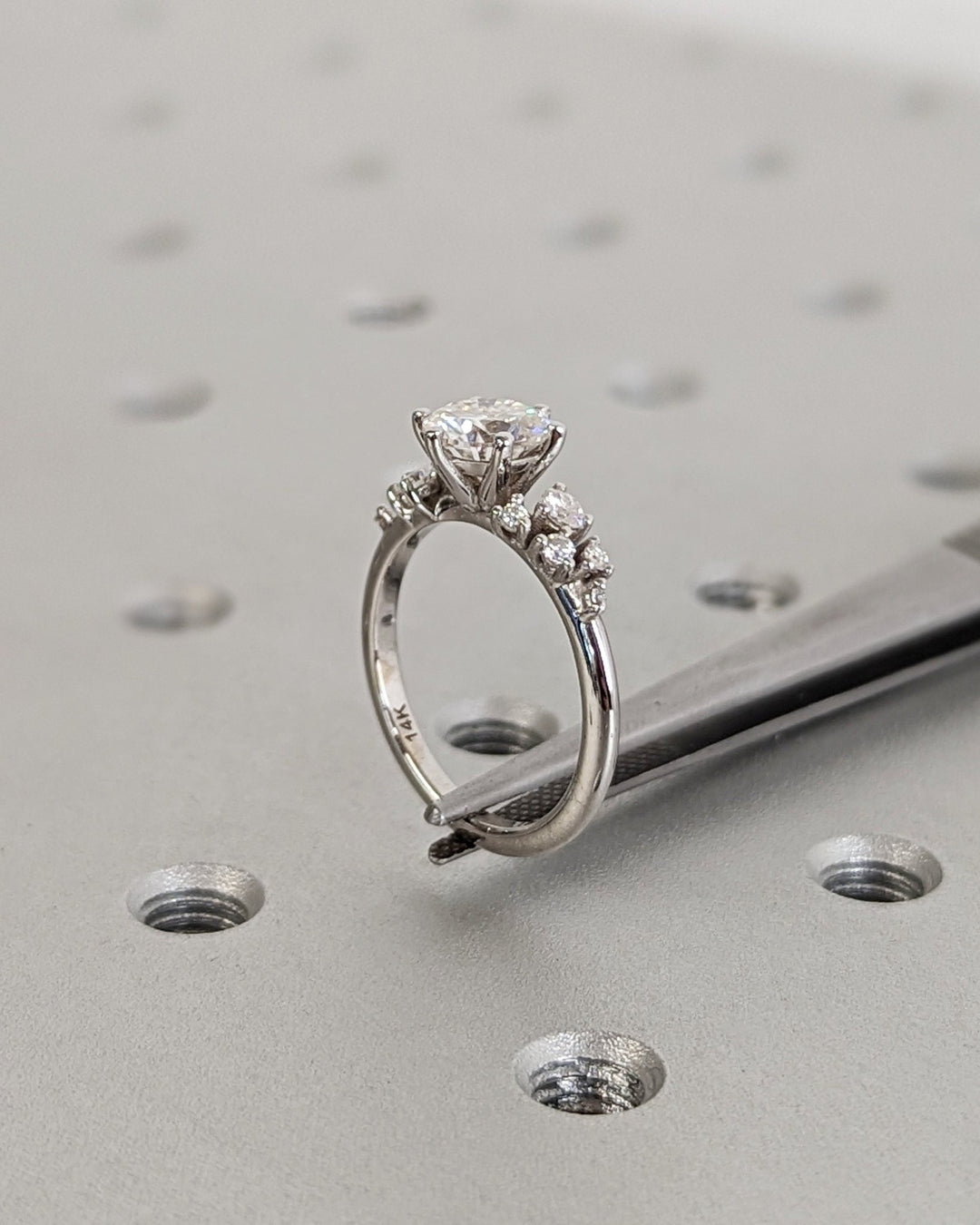 Round cluster engagement ring close-up showing high clarity diamond clarity