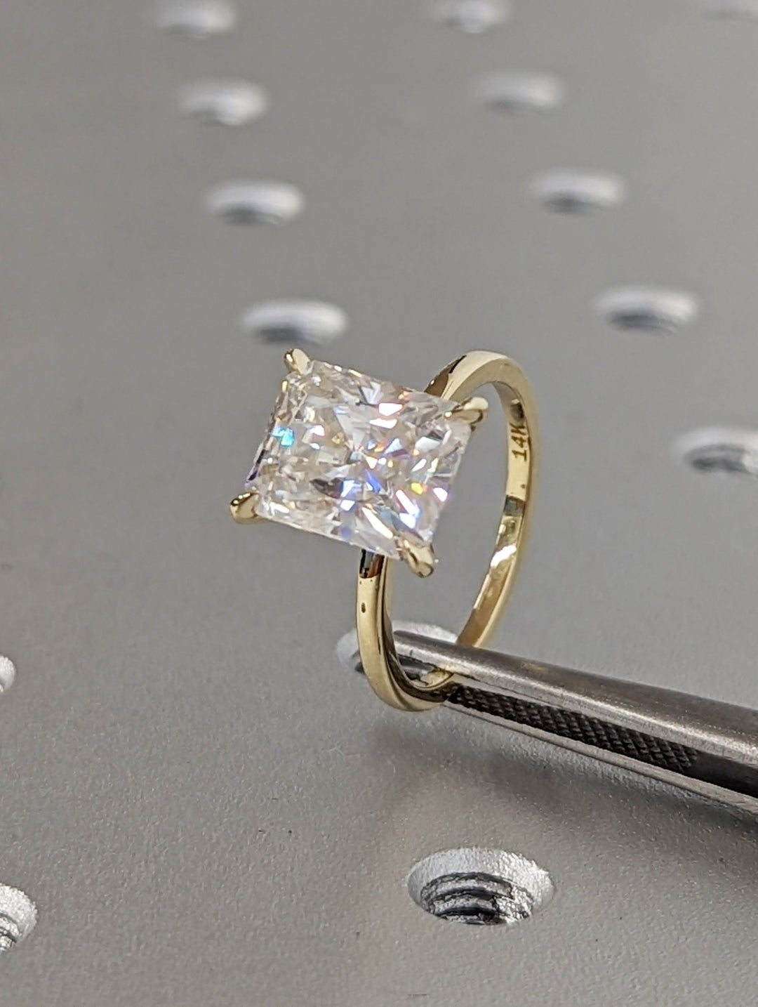 Radiant solitaire engagement ring viewed from the side