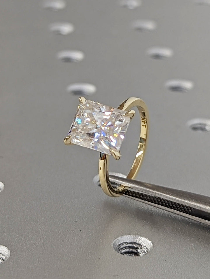 Radiant solitaire engagement ring viewed from the side