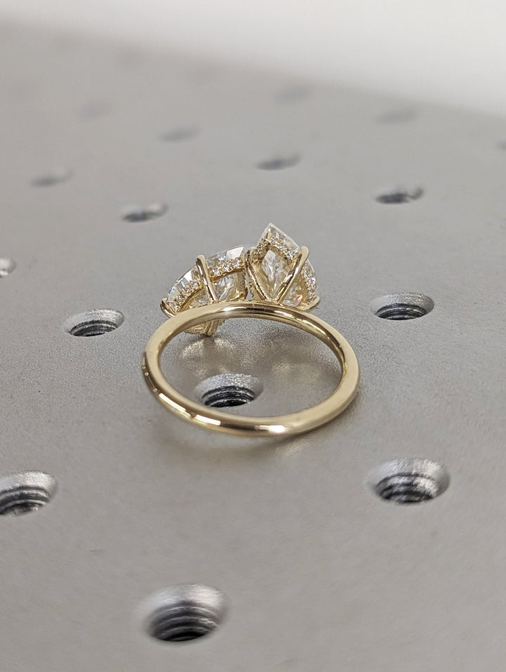 Pear hidden halo engagement ring shown on hand for true-to-life sizing