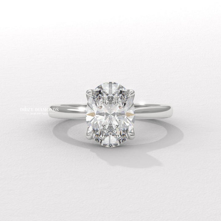 Oval solitaire engagement ring photographed in natural light