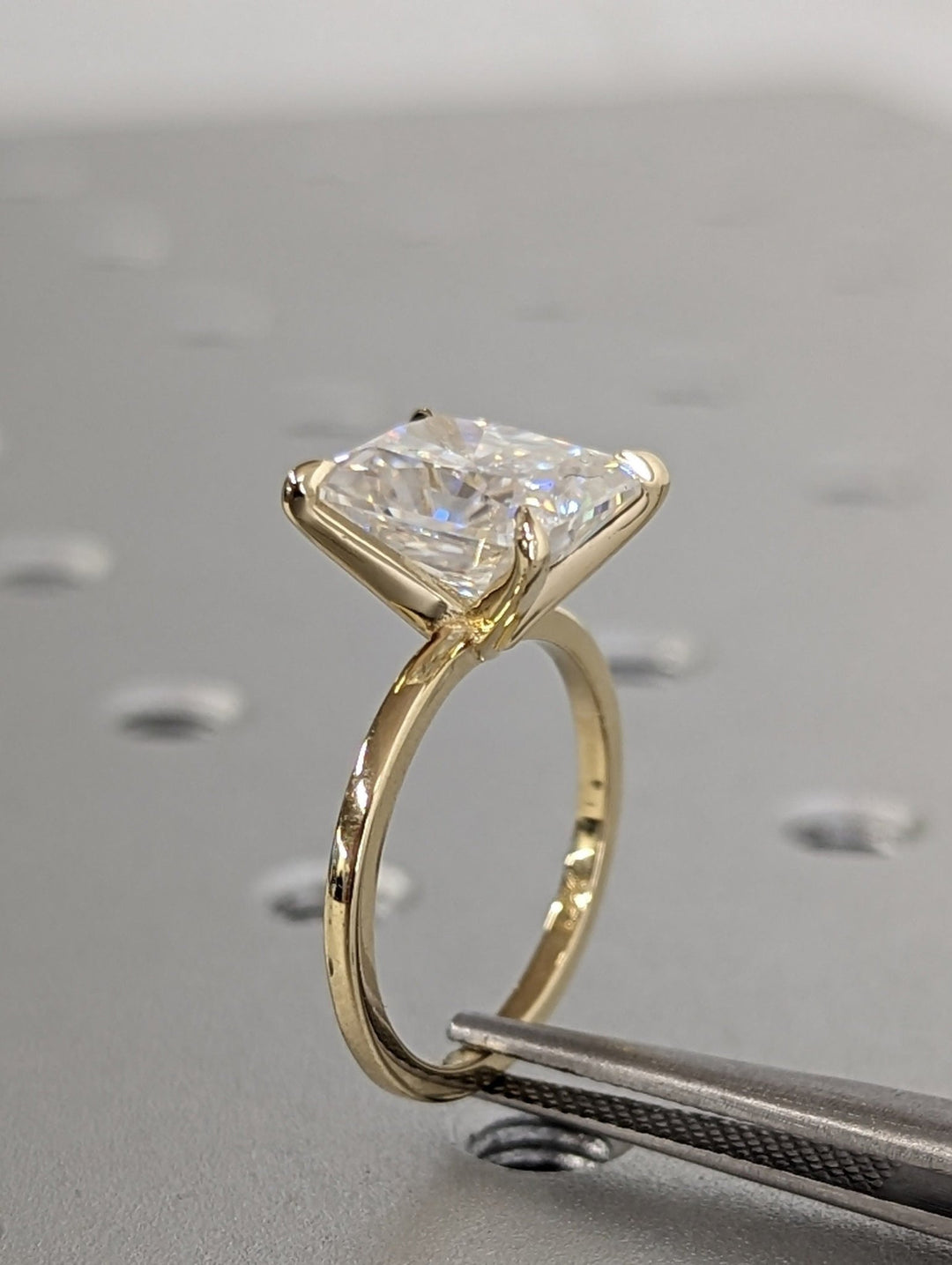 Lifestyle shot of radiant solitaire diamond ring on hand