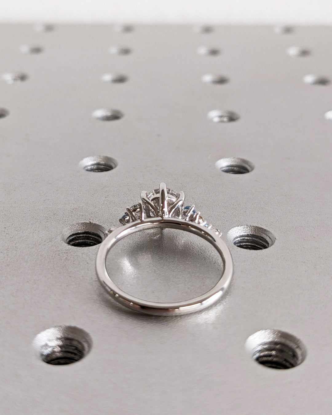 Detailed close-up of round cluster diamond engagement ring