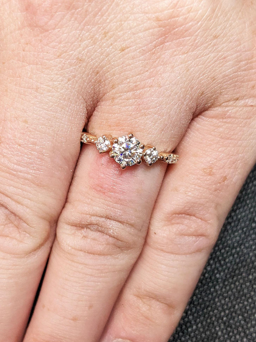Top-down view of round cut cluster engagement ring