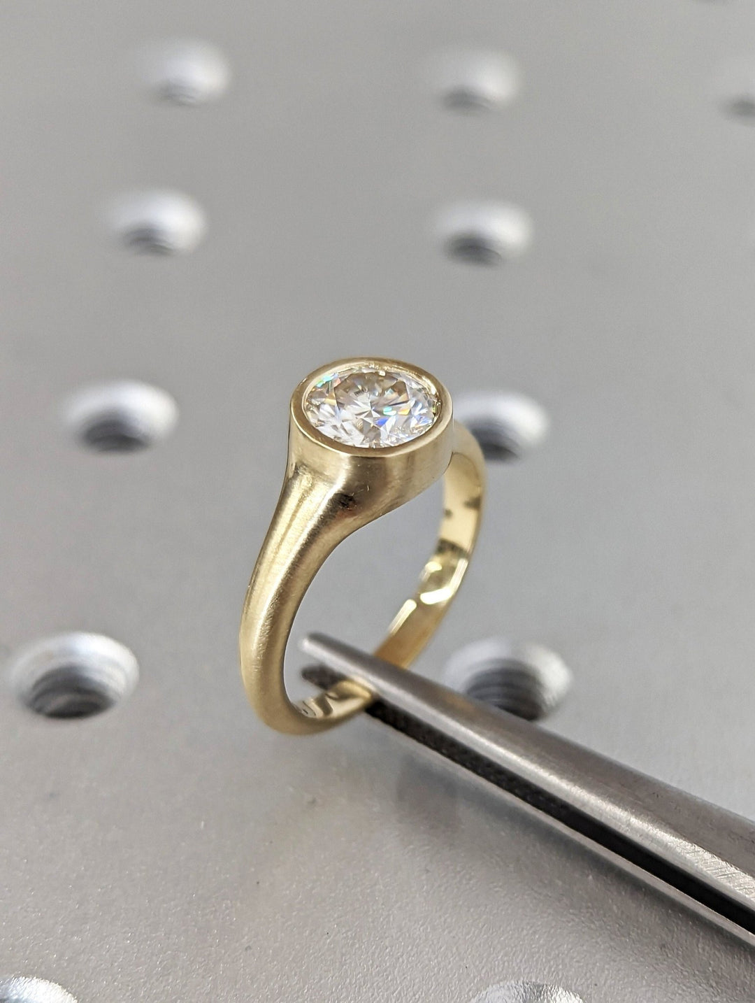 IGI certified round cut diamond in bezel engagement ring setting