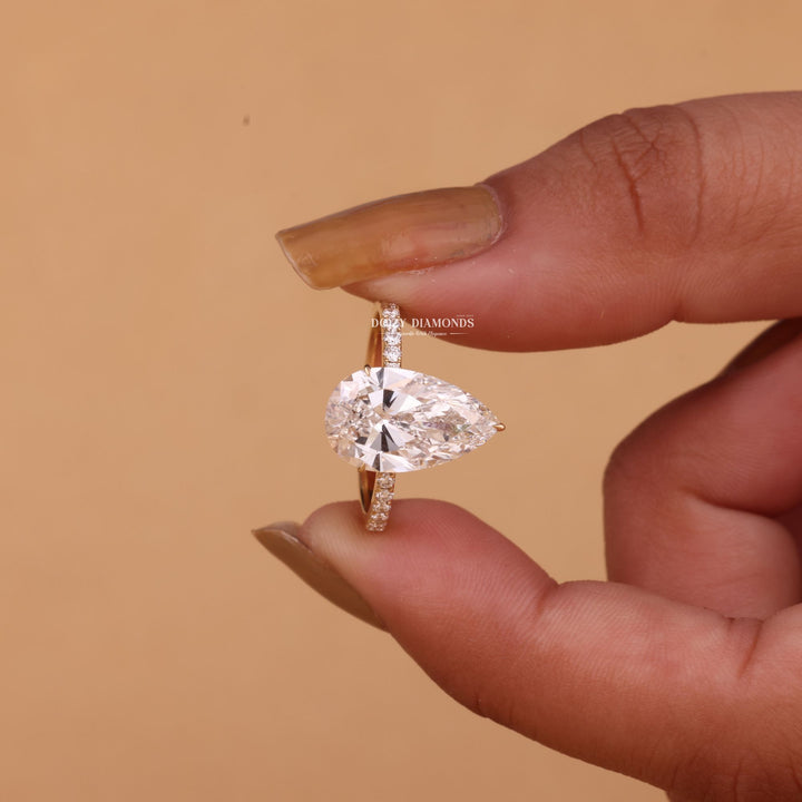 Profile view of pear cut hidden halo engagement ring band