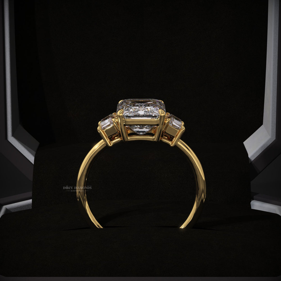 Certified emerald cut diamond featured in three stone engagement ring