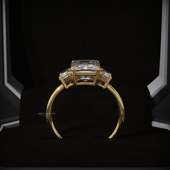 Certified emerald cut diamond featured in three stone engagement ring