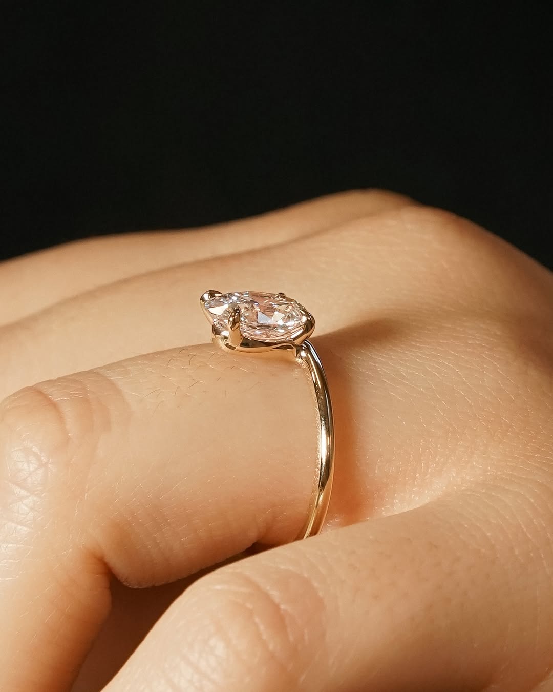 Side angle of oval solitaire diamond engagement ring