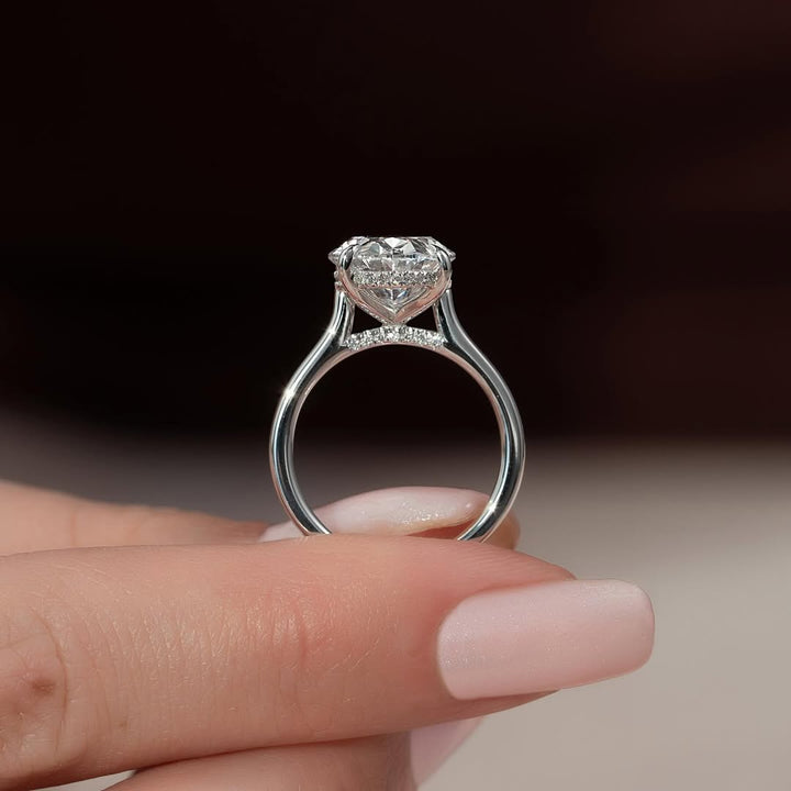 Detailed close-up of oval hidden halo diamond engagement ring