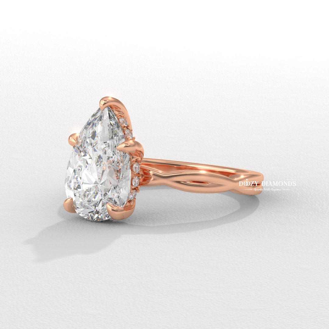 Pear solitaire engagement ring shown on hand for true-to-life sizing
