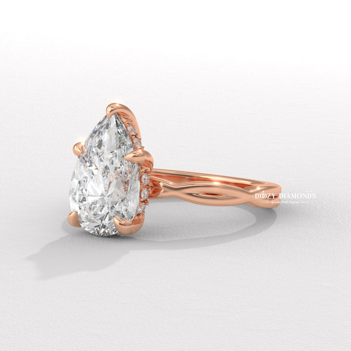 Pear solitaire engagement ring shown on hand for true-to-life sizing